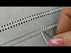 someone is stitching something on a piece of fabric