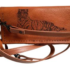 This Is A Unique 100% Vegetable Tanned Leather Wallet And Cross Body Phone Carrier With A 25-30 Inch Calf Skin Removable And Adjustable Strap And Secure Velcro Closures. It Has A Unique Laser Printed Tiger On The Front. It Is Sewn Together By Hand With Chinois Noir Thread, A Stronger And Thicker Thread Used By Luxury Bag Makers. It Closes With Heavy Duty Velcro Straps To Keep Everything Secure. It Fits A Plus Size Cased Cell Phone As Well As Cash And Multiple Cards. It Is Designed To Last Years Brown Crossbody Wallet For On-the-go, On-the-go Brown Crossbody Wallet, Brown Leather Clutch With Mobile Phone Bag, Leather Crossbody Wallet With Snap Closure, Brown Leather Clutch With Snap Closure, Casual Leather Wallet With Removable Pouch, Light Brown Leather Wallet For Everyday Use, Brown Bifold Clutch For Everyday Use, Brown Bifold Clutch