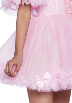 This mini dress has a tulle construction, an off the shoulder design with fabric lace and bow detailing, a ruffled trim, and a back zipper closure. Tulle Dresses With Bow, Pink Bow Mini Dress For Wedding, Pink Mini Dress With Bow For Wedding, Pink Ruffled Party Petticoat, Pink Lace Dress With Attached Cancan, Party Petticoat With Attached Cancan In Pink, Pink Mini Dress With Tulle Skirt, Pink Mini Length Tulle Mini Dress, Pink Mini Dress With Lace Trim For Wedding