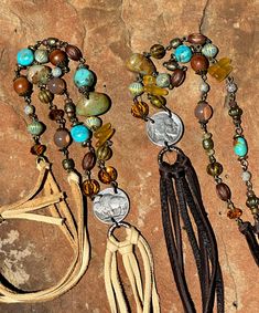 Vintage bronze sequence featuring: * Citrine and turquoise palette * Kingman turquoise nuggets * buffalo nickel lariat style * leather tassel (5 1/2 ") * Soft Napa leathers * Sterling silver slide bead (slide allows wearer to adjust length as desired) Total length (including tassel) = 48 inches    *Necklace total drop = 24 inches  ADJUSTABLE Limited quantities Bohemian Concho Lariat Necklace, Bohemian Lariat Concho Necklaces, Bohemian Lariat Concho Necklace, Bohemian Lariat Jewelry For Western-themed Events, Artisan Brown Jewelry With Tassels, Bohemian Brown Beaded Lariat Necklace, Bohemian Leather Lariat Jewelry, Buffalo Nickel, Kingman Turquoise