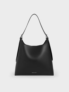 Minimalist and modern, this Hertha hobo bag offers excellent style mileage -- you will find yourself reaching for it all the time. Offering both style and functionality, this distinctive trapeze bag in timeless black can be dressed up or down according to your preferences and needs. With a roomy interior that can hold everything you need in a day, its minimalist design makes it suitable for both work and play. Its magnetic closure ensures both security and accessibility. Slouchy Hobo Bag, Trapeze Bag, Belt Ring, Charles Keith, Kids Sale, Belt Size, Hobo Bag, Magnetic Closure, Sales Gifts