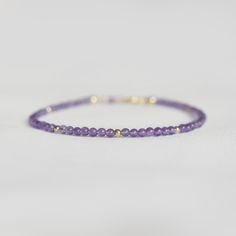 "Say hello to the daintiest Amethyst bracelet there ever was. It features a most elegant selection of genuine, natural gemstones, so you may notice oh-so-subtle variations from stone to stone. This bracelet makes a wonderful gift for someone with a February birthday, or any Amethyst lover in your family or friend circle. To find your bracelet size, simply measure the circumference of your wrist by wrapping a string around it and measuring the length of the string. Round up to the nearest half in Delicate Purple Jewelry For Everyday, Delicate Purple Jewelry For Everyday Wear, Minimalist Purple Jewelry For Everyday, Delicate Everyday Amethyst Jewelry, Adjustable Lavender Birthstone Jewelry, Adjustable Lavender Jewelry For Everyday, Minimalist Everyday Purple Jewelry, Dainty Beaded Bracelets For Birthday, Purple Bracelet Jewelry For Everyday