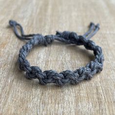 a close up of a bracelet on a wooden surface