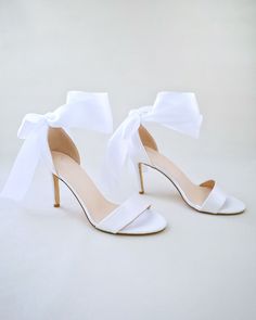 "Classic satin high heel sandals adorned adorned with matching satin or sheer ribbons that ties to an oversized bow around ankle to add dancerly grace to any ensemble. The light blue color can easily be your something blue. Simple and easy wear for bridal wear, bridesmaids, holiday party, wedding parties, and any special occasions.  DETAILS: HEEL HEIGHT: 3.5 Inches COLORS AVAILABLE: Ivory, Light Blue, Champagne, White, Fuchsia UPPER: Synthetic upper and lining MATERIALS: Manmade outsole STYLE NAME: DEMI Not sure of which size to purchase? Shoes measurements are as follow: (Please note measurements taken the length of inside of shoe from toe to heel). Size 6 - 9.25\" Size 7 - 9.5\" Size 8 - 9.75\" Size 9 - 10\" Size 10 - 10.25\" Size 11 - 10.5\" Please note all these info are intended for g Luxury White Satin Heels, Open Toe Sandals With Bow For Wedding, Summer Bridesmaid Wedding Shoes With Bow, Wedding Ankle Strap Sandals With Satin Bow, Open Toe Sandals With Satin Bow For Wedding, High Heel Wedding Sandals With Bow, Prom Sandals With Satin Bow And Open Toe, Party Heels With Satin Bow In White, Wedding High Heel Sandals With Bow