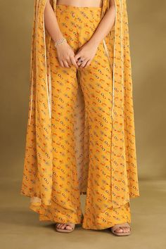 Dandelion yellow cape with floral, ikat print and zari thread, sequin embroidered panel. Paired with printed blouse and flared pant. - Aza Fashions Floral Cape, Dandelion Yellow, Ikat Print, Fashion App, Pant Set, Set For Women, Aza Fashion, Printed Blouse, Flare Pants