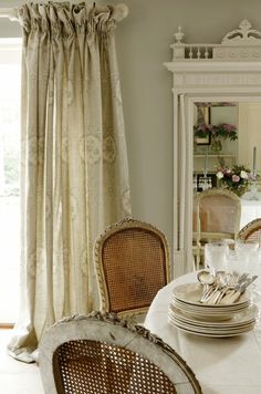 a dining room table with plates and silverware on it