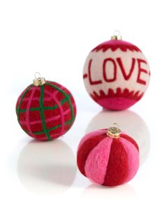 three ornaments with the word love on them