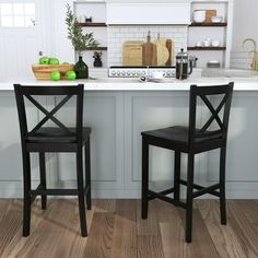 two black chairs sitting on top of a kitchen counter