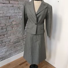 Classic Long Sleeve Skirt Suit For Tailoring, Retro Formal Skirt Suit With Buttons, Classic Tailored Skirt Suit, Classic Tailored Skirt Suit With Button Closure, Classic Notch Lapel Skirt Suit With Buttons, Classic Skirt Suit With Notch Lapel, Vintage Office Skirt Suit With Buttons, Vintage Fitted Skirt Suit With Notch Lapel, Vintage Skirt Suit With Buttons For Office