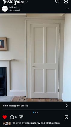 an instagram photo of a living room with white walls and wood flooring, including a fireplace