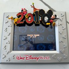 a photo frame with mickey mouses on it