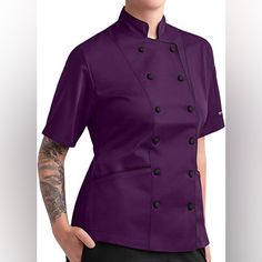 Women’s Tailored Button Down Chef Coat With Piping. Color Is A Gorgeous Eggplant Purple. Chef Coat Has A Stand-Up Mandarin Style Collar And An Adjustable Back Tie Belt. Both Features Add A Nice Touch Of Professionalism To The Coat. Most Importantly The Chef Coat Has 2 Side Pockets!! Best Part Of The Chef Coat In My Opinion. Super Easy To Clean! Just Machine Wash And Tumble Dry. Can Iron If Needed. Material Is A Blend Of 65% Polyester And 35% Cotton. Coat Feels Comfy And Is Too Heavy. Comfortable Black Chef Uniform, Purple Buttoned Workwear Outerwear, Purple Buttoned Outerwear For Work, Purple Outerwear With Button Closure For Work, Purple Button-up Outerwear For Work, Purple Button-up Outerwear With Button Closure, Purple Button-up Outerwear, Purple Buttoned Tops For Work, Purple Office Tops With Buttons