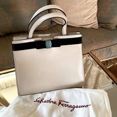 Ferragamo Satchel Handbag New With Tags Cream & Black Neutral Dustbag Included Hardware Covered & Protected Matte Gold & Leather Chain High-end Cream Shoulder Bag For Evening, High-end Cream Top Handle Bag, High-end Cream Office Bag, Luxury Cream Rectangular Bag, High-end Cream Bags With Detachable Handle, Luxury Cream Shoulder Bag For Shopping, Luxury Cream Shopping Bag, Elegant Square Bag, Cream Square Evening Bag