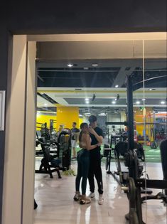 two people standing in front of a gym