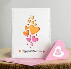 a valentine's day card with hearts on it and a heart shaped block next to it