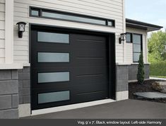 a black garage door on the side of a house