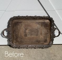 an old metal tray sitting on the ground next to a white door with words before and after