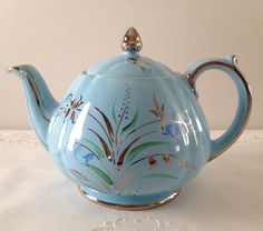 a blue tea pot sitting on top of a table