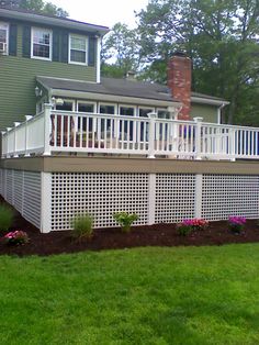 a house with a deck and white railing