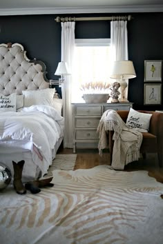 a bedroom with a bed, chair and pictures on the wall