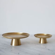 two brass plates sitting on top of a marble counter