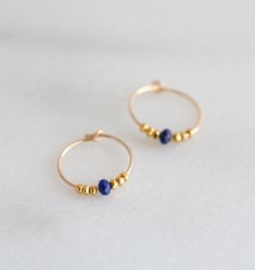 Beautiful 14 carat mini gold filled hoops adorned with natural faceted Lapis Lazuli gemstones and little Karen Hill Tribe gold vermeil beads. If you would like to personalise this piece by changing the gemstones or colour, or if you would like rose gold filled or sterling silver, please let me know in the personalisation section. Earring length 15mm Earrings are for pierced ears and in 14 carat gold filled. Each piece of Salt Bijoux jewellery comes beautifully packaged in luxurious branded boxes Everyday Jewelry With Faceted Beads In 14k Gold Filled, Yellow Gold Beaded Hoop Earrings For Gift, Adjustable Gold Hoop Earrings With Faceted Beads, Gold Bead Hoop Jewelry Gift, Small Hoop Jewelry With Faceted Beads For Gifts, Yellow Gold Jewelry With Faceted Beads For Gift, Handmade Lapis Lazuli Jewelry For Everyday, Adjustable Gold Beads Hoop Earrings As Gift, Adjustable Gold Beaded Hoop Earrings As Gift