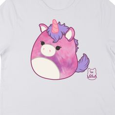 Hang out with your favorite unicorn with this Squishmallows tee. The shirt features an image of Lola the Unicorn sitting next to purple letters that spell out her name. The tee comes in a white short sleeve crew neck. Squishmallows fans will love this comfy cotton t-shirt. Purple Cartoon Print Fun T-shirt, Purple Graphic Print Kawaii T-shirt, Purple Kawaii T-shirt With Graphic Print, Kawaii Purple T-shirt With Graphic Print, Purple Crew Neck T-shirt In Kawaii Style, Playful Purple T-shirt With Graphic Print, Purple Short Sleeve Kawaii T-shirt, Purple Kawaii Short Sleeve T-shirt, Playful Purple Graphic Print T-shirt