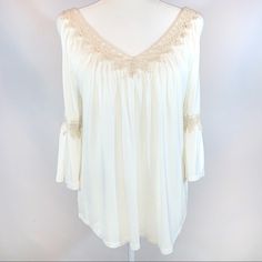 G Collection Size S Ivory Boho V-Neck W Lace Cutout 3/4 Bell Sleeve Tie Blouse V-Neck Front & Back W Crocheted Lace Trim Open V-Neck Back Ties At Top 3/4 Bell Sleeves Have Openening On Sides At Top W Tan Crocheted Lace At Elbow Loose Flowy Fit W Ruching At Top Rounded Hemline Soft Comfy Rayon/Spandex Blend Stretch Knit Fabric Excellent Nwot Condition!! Lno Flaws! Pit To Pit 22” Length From Shoulder 27” Sleeve Length 17” A0215 Off White V-neck Top With Lace Trim, White Tops With 3/4 Sleeve And Lace Trim, White Half Sleeve Blouse For Brunch, Cream V-neck Blouse For Brunch, White Bohemian Half Sleeve Tops, Chic Cream Blouse With 3/4 Sleeves, Feminine White Half-sleeve Blouse, Feminine White Half Sleeve Blouse, Off White V-neck Blouse For Spring