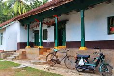 two bikes parked in front of a building