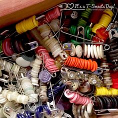 many different colored buttons and pins in a wooden box with text overlay that reads, i love it & t - sweet day