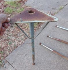 an old rusted metal table sitting on top of a sidewalk