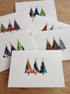 six cards with colorful christmas trees on them