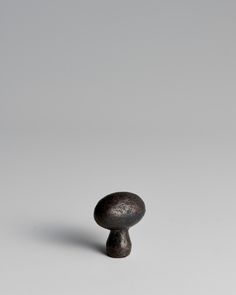 a black object sitting on top of a white surface