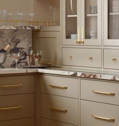 a kitchen with marble counter tops and gold trim on the cabinet doors is pictured in this image