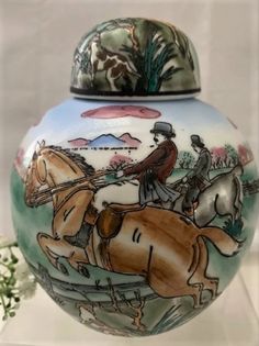 a vase with a horse and rider painted on it