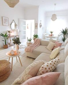 a living room filled with lots of furniture and pillows on top of it's couches