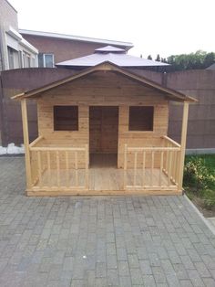 a small wooden building sitting on top of a brick sidewalk