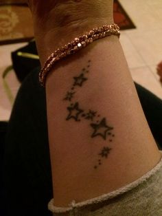 a woman's arm with stars on it