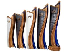 three tall wooden trophies with blue and white designs