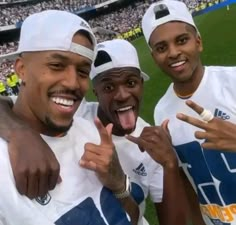 three men standing next to each other at a soccer game