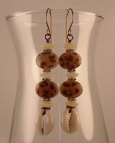 Animal Print Afrocentric Cowrie Shell African Earrings Tribal Bohemian Bronze Earrings With Round Beads, Nickel-free Brown Beaded Earrings For Festival, Bohemian Brown Beaded Nickel-free Earrings, Beach Beaded Metal Earrings, Metal Beaded Earrings For Beach, Handmade Metal Beaded Earrings For Beach, Bohemian Beaded Earrings With Round Metal Beads, Bohemian Metal Beaded Earrings, Bohemian Metal Beaded Earrings With Round Beads