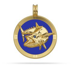 a gold pendant with a blue background and an image of a shark on the front