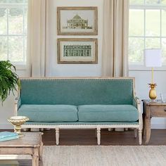 a living room with two couches and a coffee table in front of the window