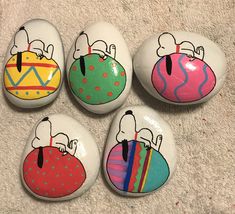 four painted rocks with cartoon characters on them