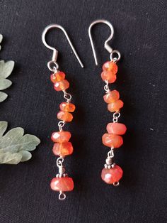 Carnelian gemstone beaded silver earring, earring gift for her, carnelian faceted rondelle beads earrings, boho earring, every day earrings, gift for daughter, gemstone beaded sterling silver earrings hand made with love and passion. Item: carnelian earring pair Metal: sterling silver Metal purity: 92.5% Length: 6.25 cm Handmade Amber Round Bead Earrings, Handmade Amber Beaded Round Earrings, Handmade Agate Round Bead Earrings, Handmade Amber Earrings With Round Beads, Amber Beaded Drop Earrings For Gift, Handmade Amber Agate Earrings, Dangle Beaded Earrings With Gemstone Beads As Gift, Gift Gemstone Beaded Dangle Earrings, Gemstone Beads Dangle Earrings Gift