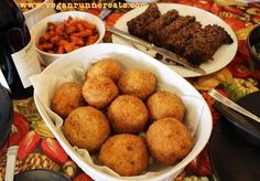 there are many different foods in bowls on the table with wine and utensils