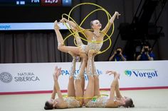 two women performing aerial acrobatic tricks with hoop in front of camera on stage