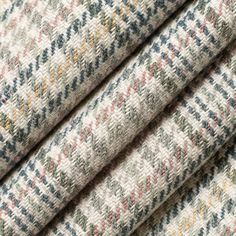 a close up shot of the fabric in grey and multicolored tweed