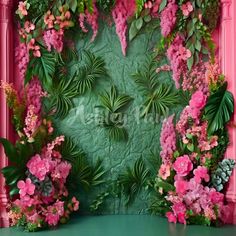 pink flowers and greenery on a green wall