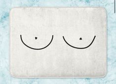 a bath mat with two eyes drawn on the front and one eye closed in half